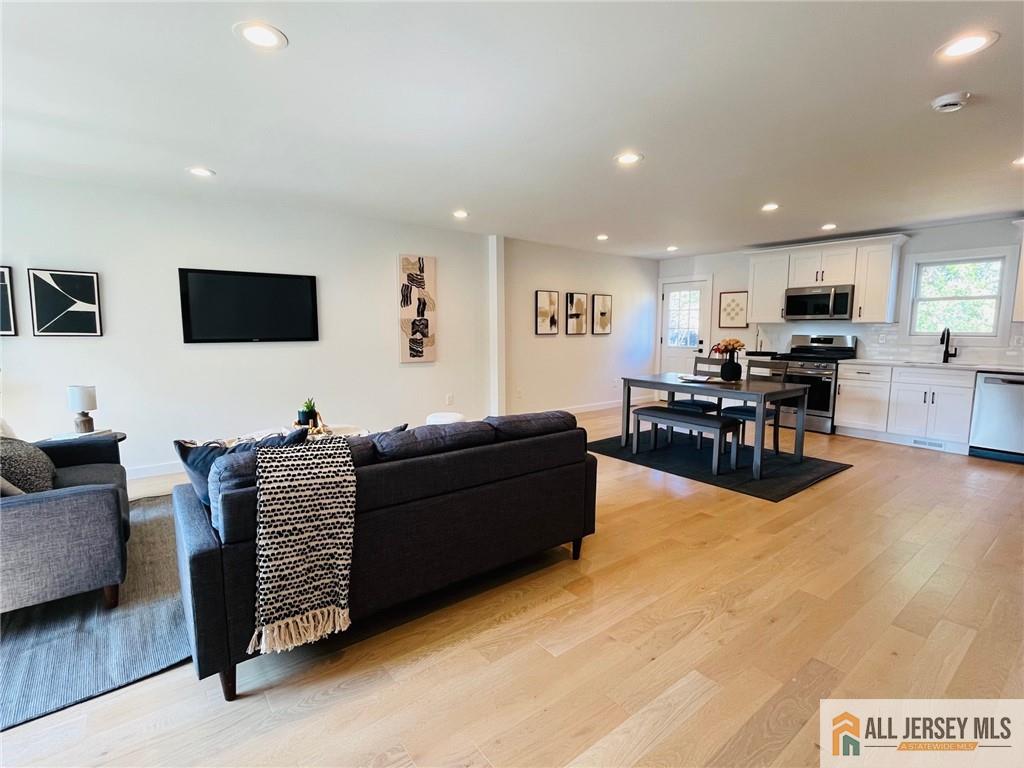 42 Larchmont Road Edison, NJ 08837 - Photo 10 of 36 a living room with furniture and a flat screen tv