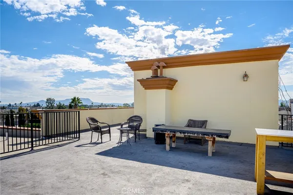a terrace of a house with outdoor seating