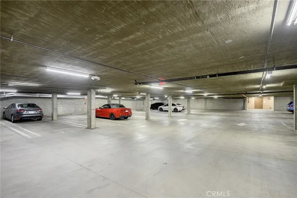a view of parking garage with cars