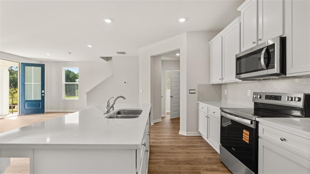 918 Stow Lane Sanger, CA 93657 - Photo 12 of 45 a kitchen with stainless steel appliances granite countertop a sink stove and refrigerator