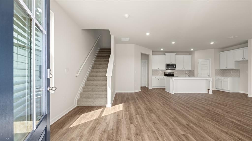 918 Stow Lane Sanger, CA 93657 - Photo 6 of 45 a view of kitchen with wooden floor and electronic appliances