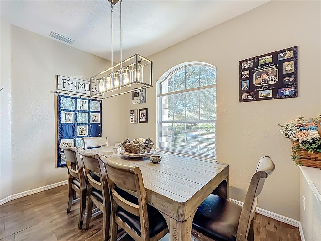 9027 Southwest 196th Court Dunnellon, FL 34432 - Photo 11 of 50 a view of a dining room with furniture window and wooden floor