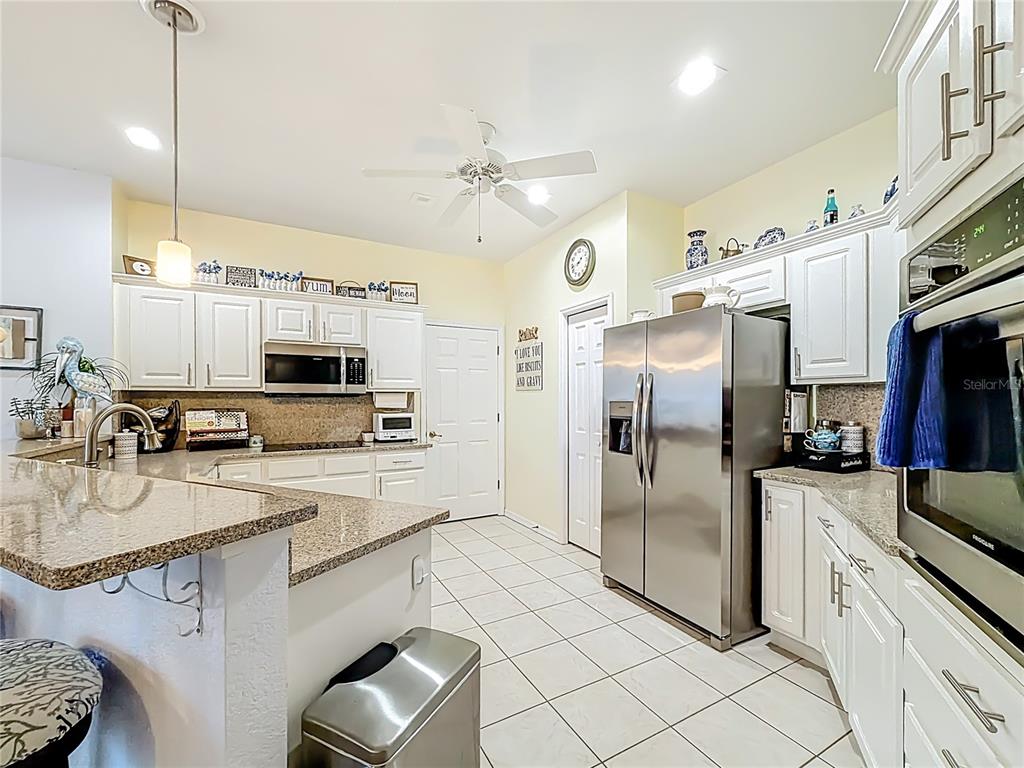 9027 Southwest 196th Court Dunnellon, FL 34432 - Photo 15 of 50 a kitchen with stainless steel appliances a refrigerator sink and microwave