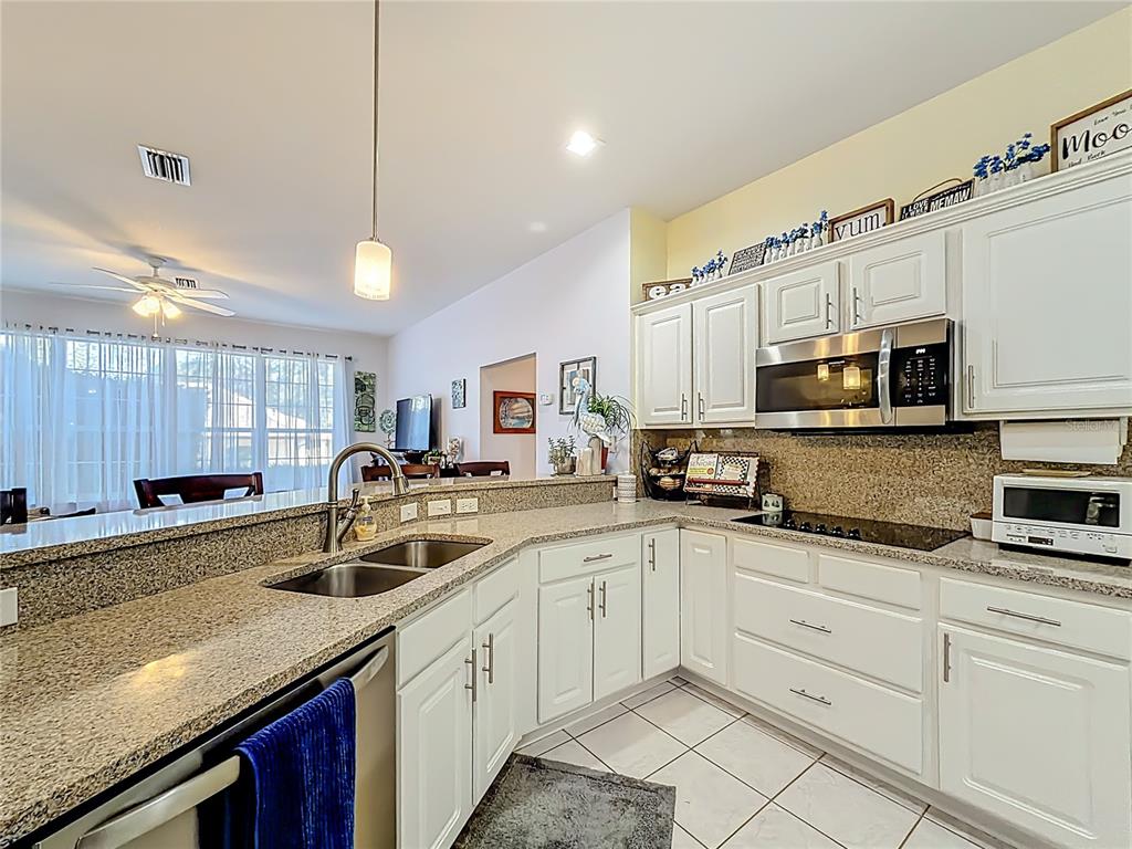 9027 Southwest 196th Court Dunnellon, FL 34432 - Photo 16 of 50 a kitchen with stainless steel appliances granite countertop a sink a stove and cabinets