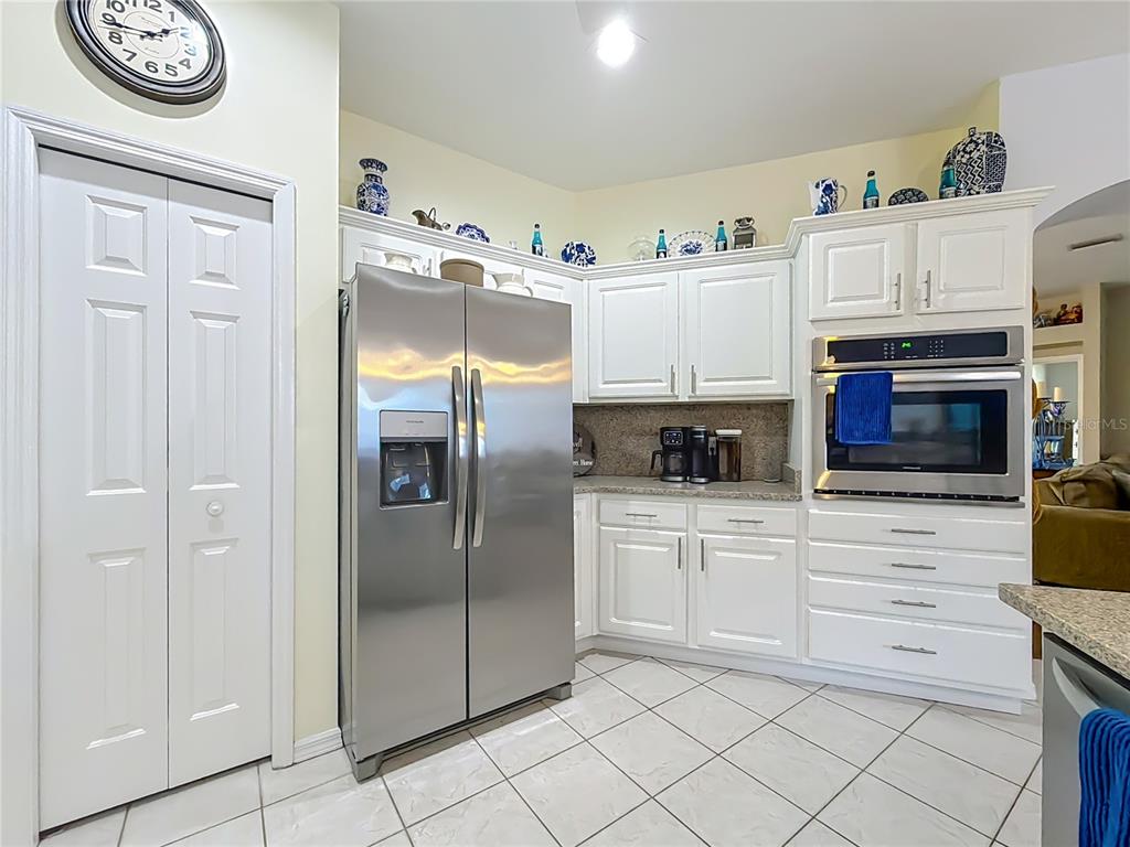 9027 Southwest 196th Court Dunnellon, FL 34432 - Photo 17 of 50 a kitchen with stainless steel appliances granite countertop a refrigerator and a stove top oven