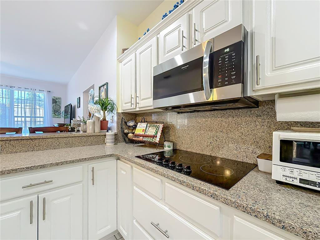 9027 Southwest 196th Court Dunnellon, FL 34432 - Photo 18 of 50 a kitchen with stainless steel appliances granite countertop a sink a stove and a microwave