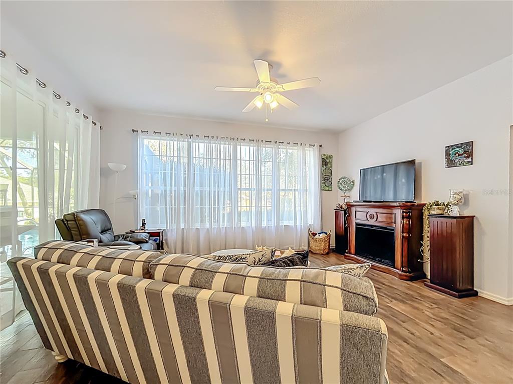 9027 Southwest 196th Court Dunnellon, FL 34432 - Photo 20 of 50 a bedroom with furniture a flat screen tv and a fireplace