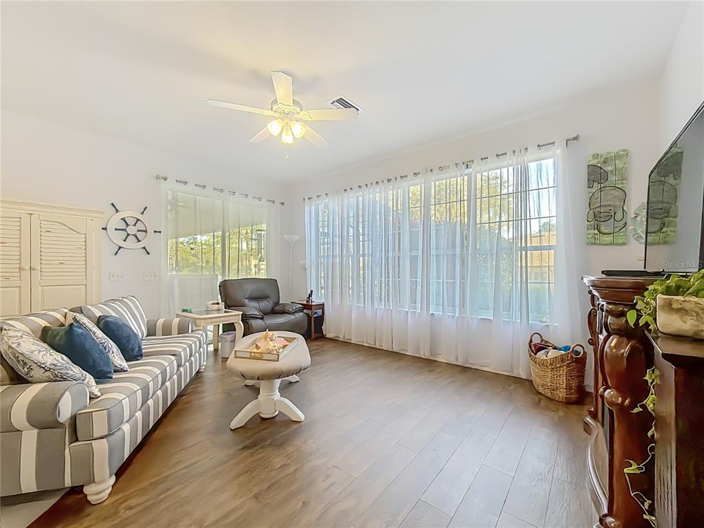 9027 Southwest 196th Court Dunnellon, FL 34432 - Photo 21 of 50 a living room with furniture and a wooden floor