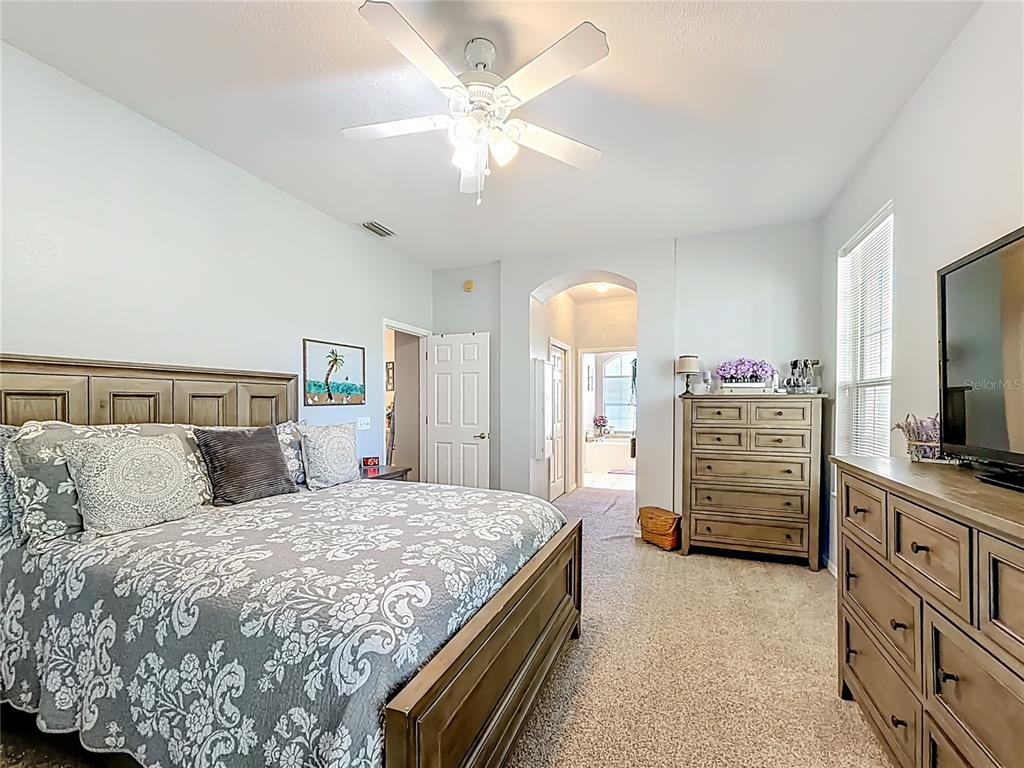 9027 Southwest 196th Court Dunnellon, FL 34432 - Photo 23 of 50 a bedroom with a bed and a flat screen tv