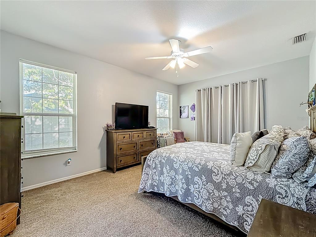 9027 Southwest 196th Court Dunnellon, FL 34432 - Photo 26 of 50 a bedroom with a bed flat screen tv and a window