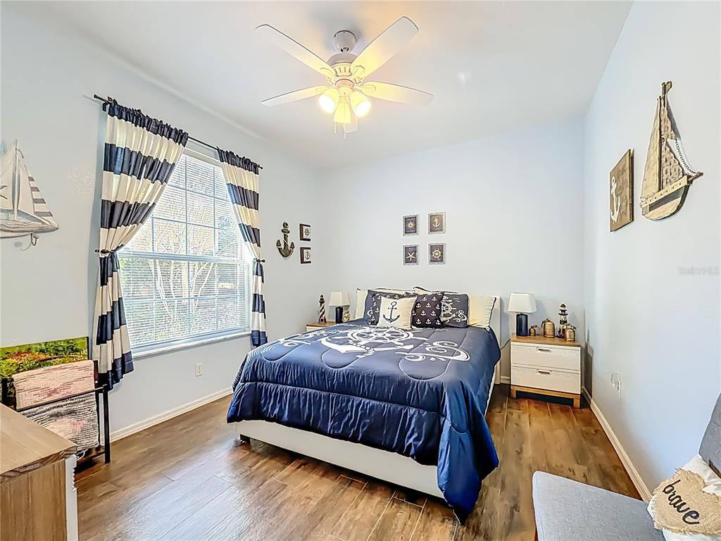 9027 Southwest 196th Court Dunnellon, FL 34432 - Photo 30 of 50 a bedroom with a bed and a couch