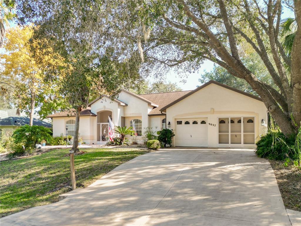 9027 Southwest 196th Court Dunnellon, FL 34432 - Photo 3 of 50 a front view of a house with a yard