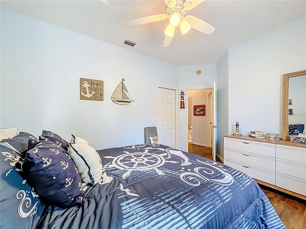 9027 Southwest 196th Court Dunnellon, FL 34432 - Photo 31 of 50 a bedroom with a bed and a chandelier