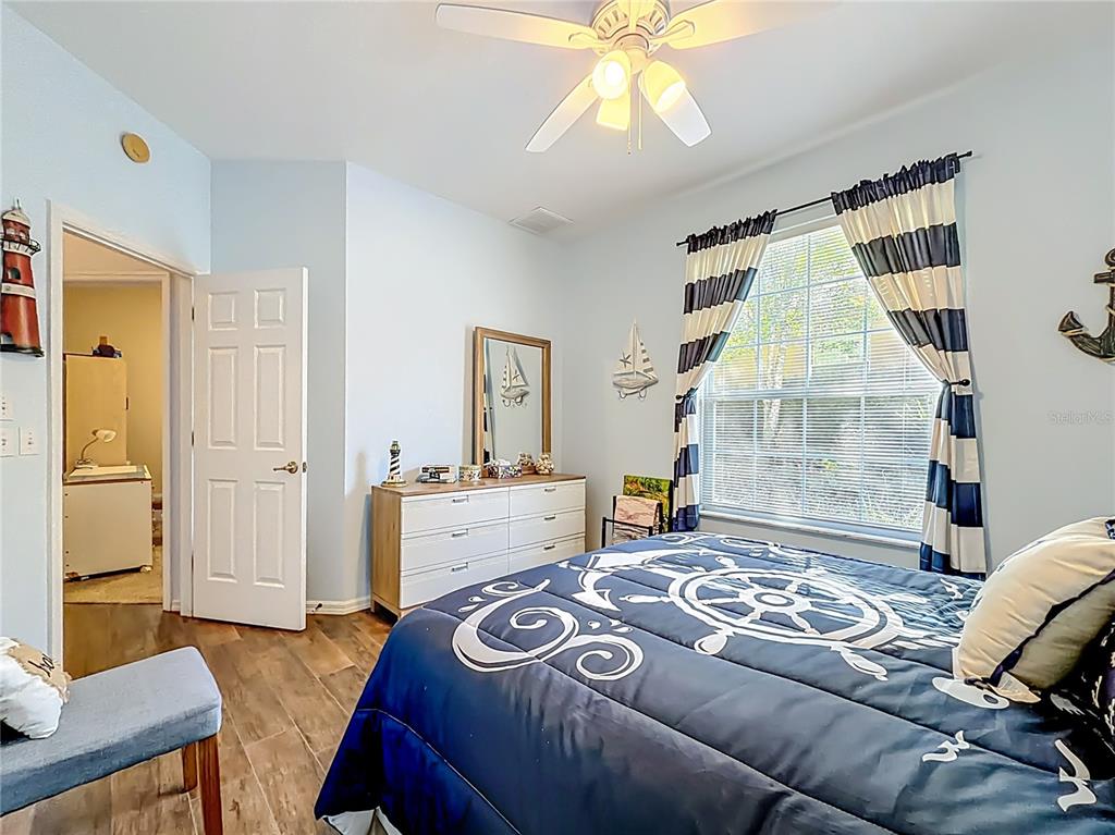 9027 Southwest 196th Court Dunnellon, FL 34432 - Photo 32 of 50 a bedroom with a bed and a chandelier