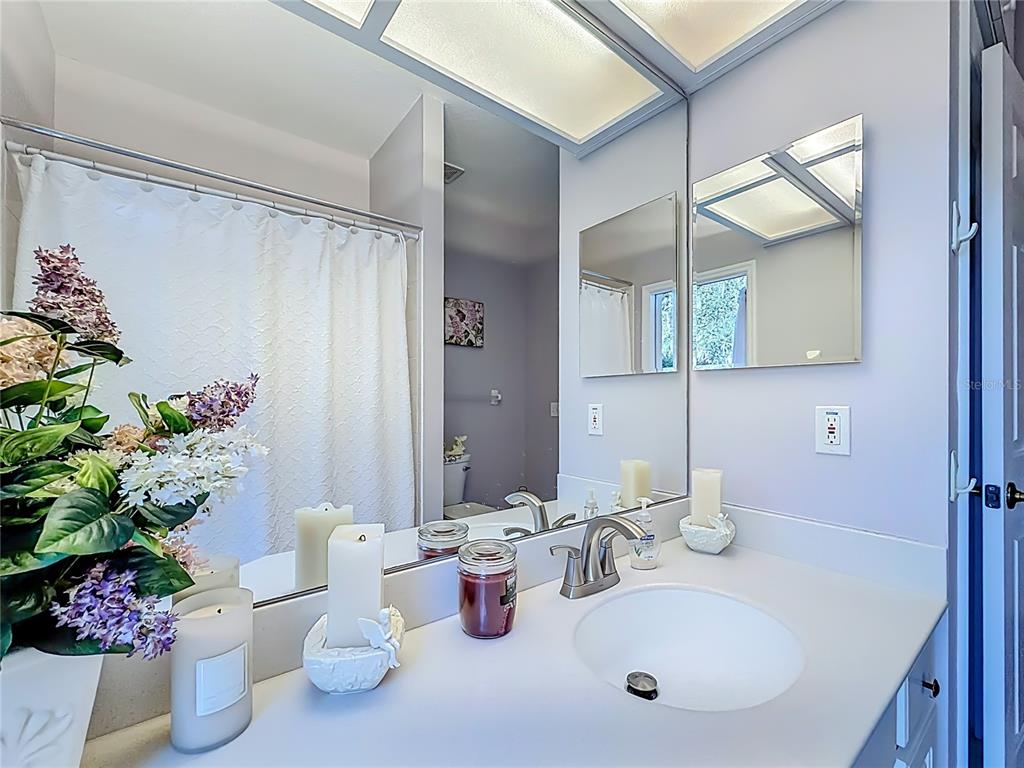 9027 Southwest 196th Court Dunnellon, FL 34432 - Photo 34 of 50 a bathroom with a sink mirror and toilet