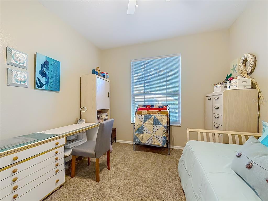 9027 Southwest 196th Court Dunnellon, FL 34432 - Photo 36 of 50 a bedroom with a bed and a table