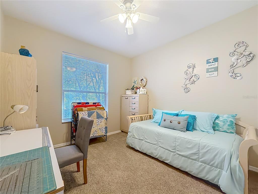 9027 Southwest 196th Court Dunnellon, FL 34432 - Photo 37 of 50 a bedroom with a bed and a chandelier