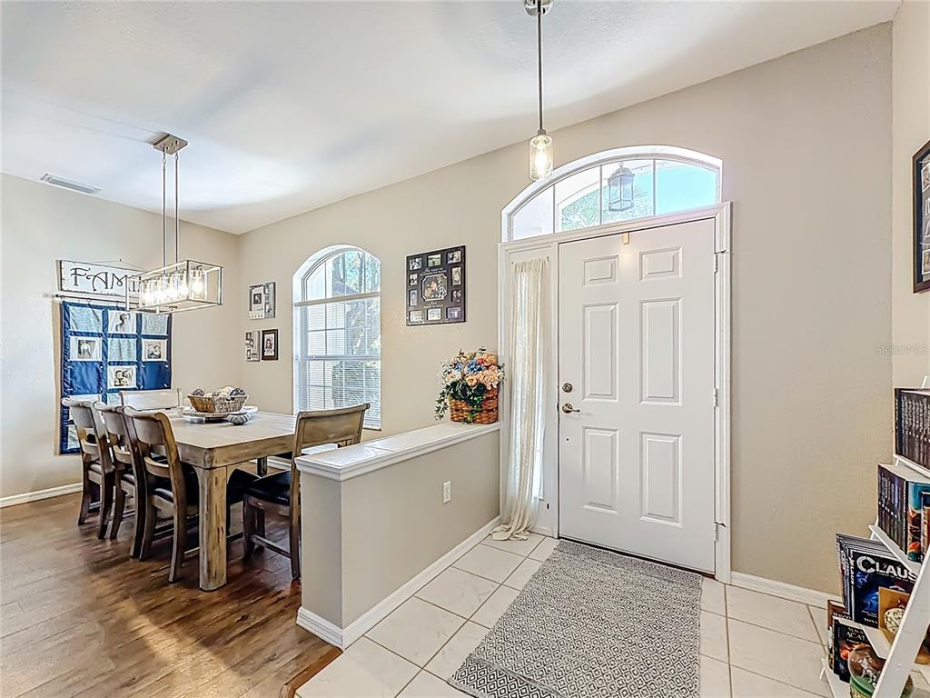 9027 Southwest 196th Court Dunnellon, FL 34432 - Photo 9 of 50 a view of a dining room with furniture and chandelier
