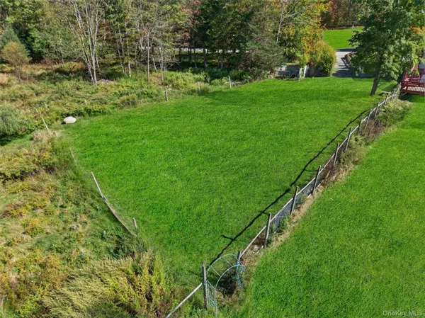 a yard with lots of green space and trees