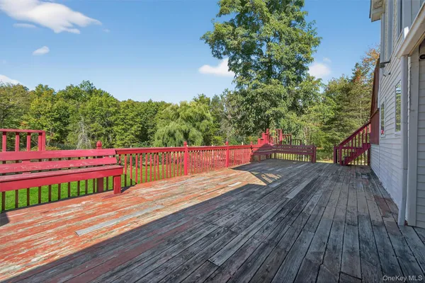 a view of yard from deck with patio