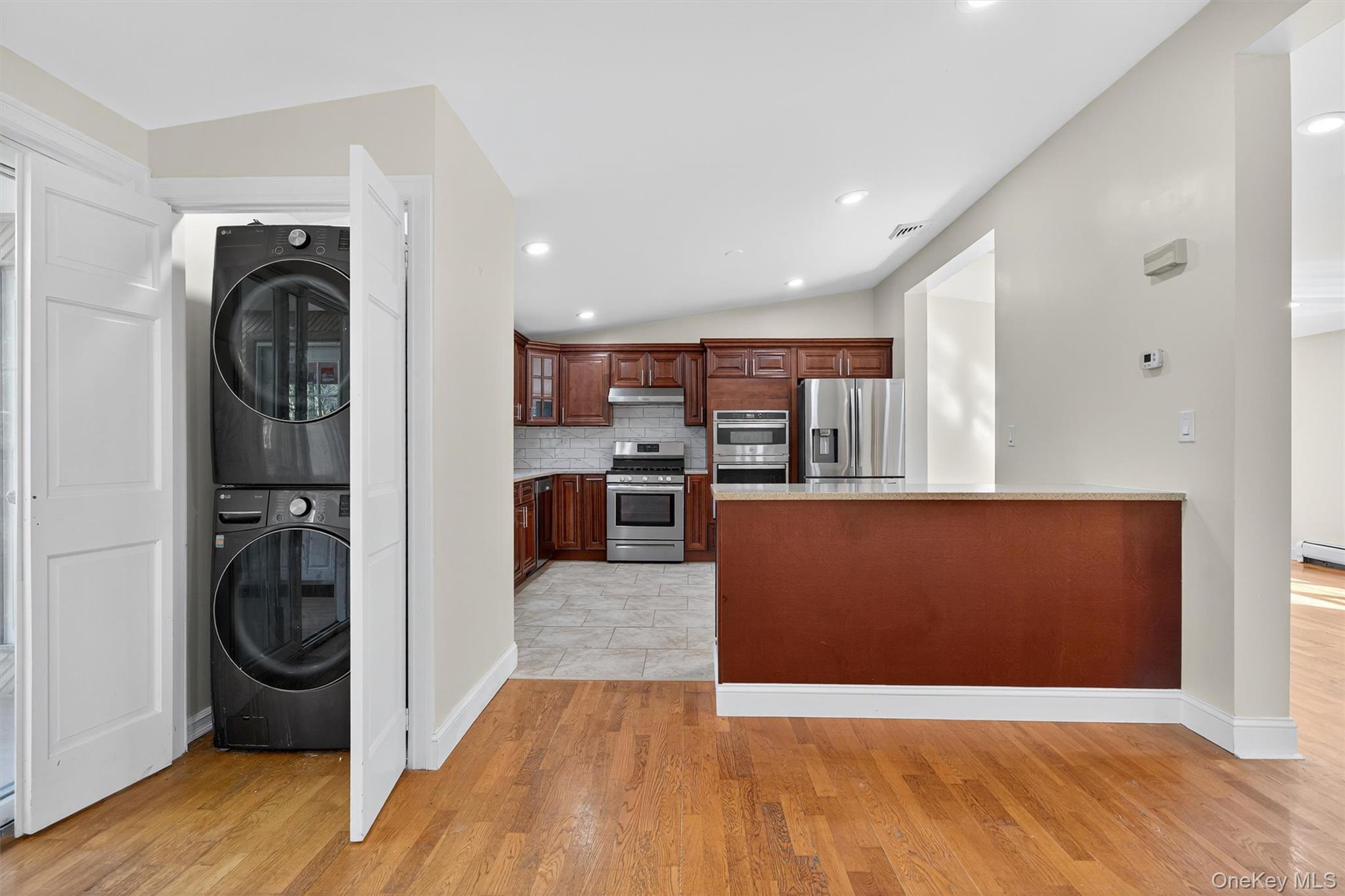 229 Gardnerville Road New Hampton, NY 10958 - Photo 20 of 50 a view of a kitchen with stainless steel appliances wooden floor and chair