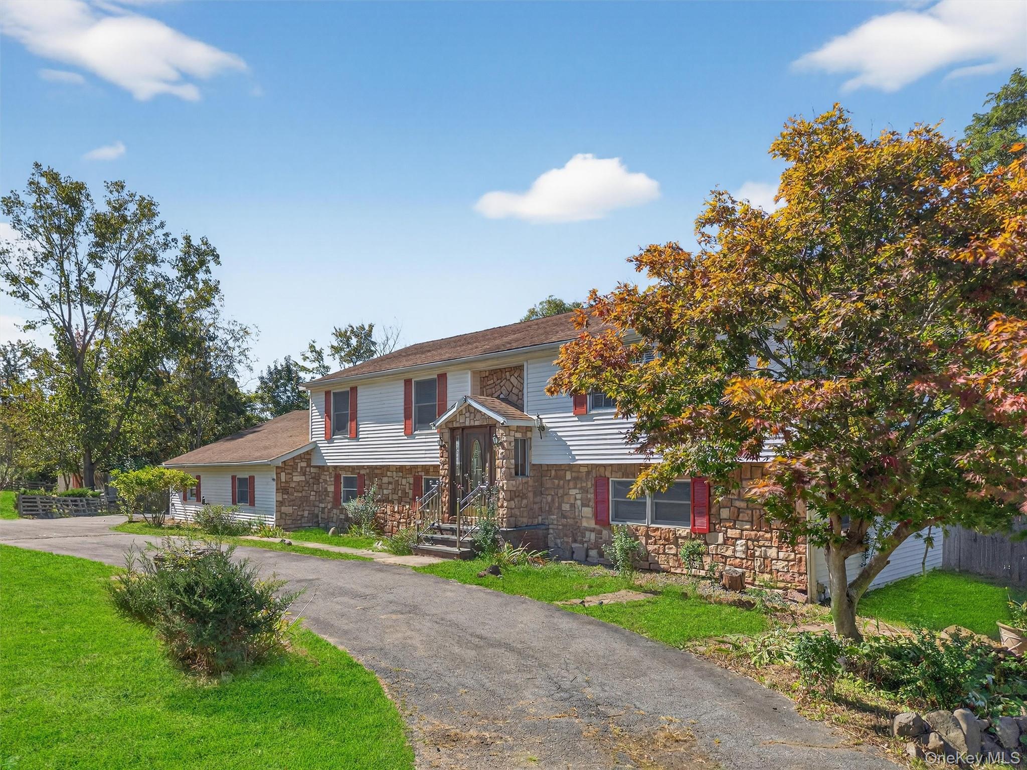 229 Gardnerville Road New Hampton, NY 10958 - Photo 2 of 50 a front view of a house with a garden and trees