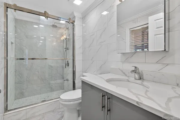 a bathroom with a sink toilet and shower