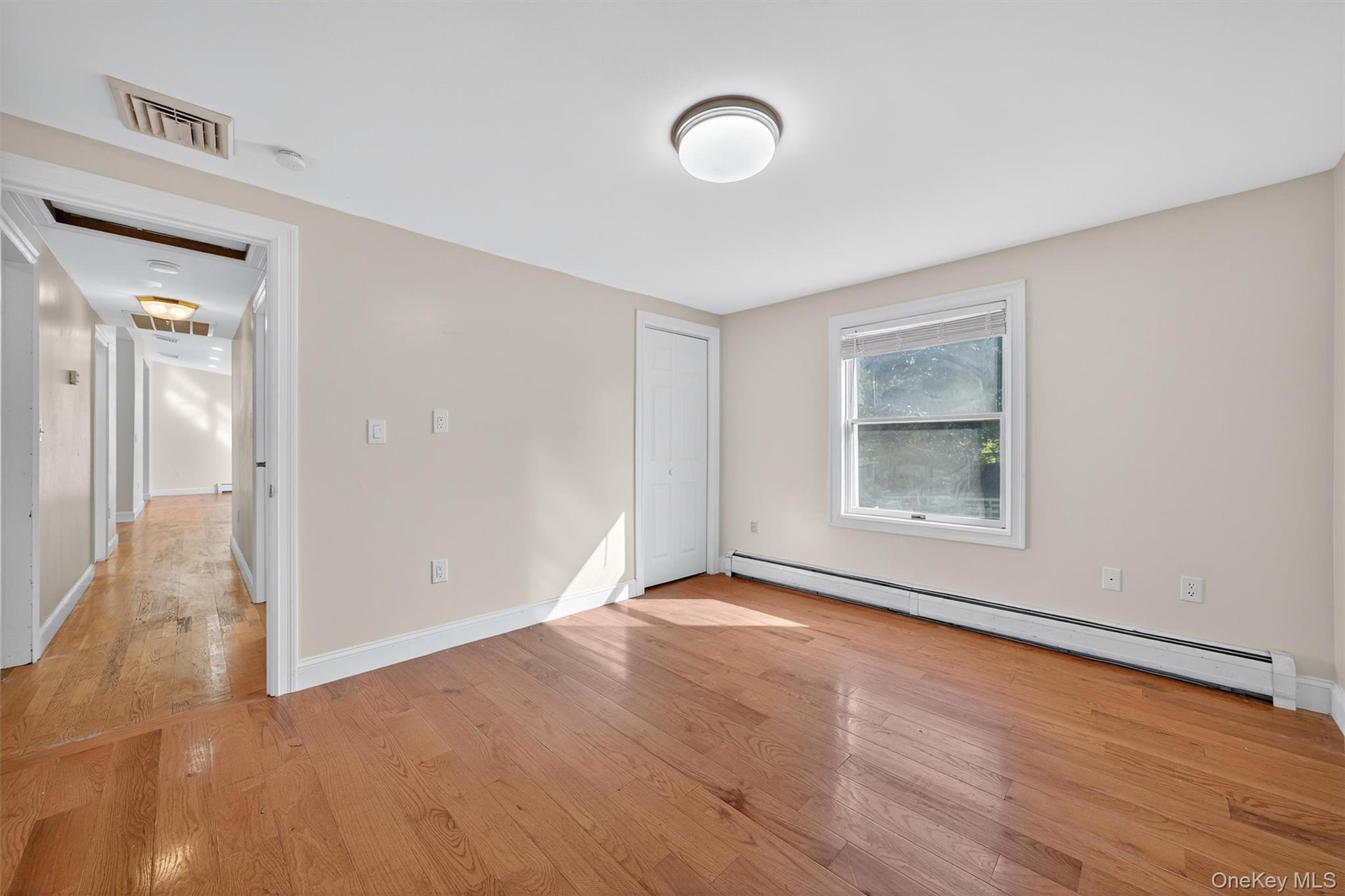 229 Gardnerville Road New Hampton, NY 10958 - Photo 26 of 50 a view of an empty room with wooden floor and a window