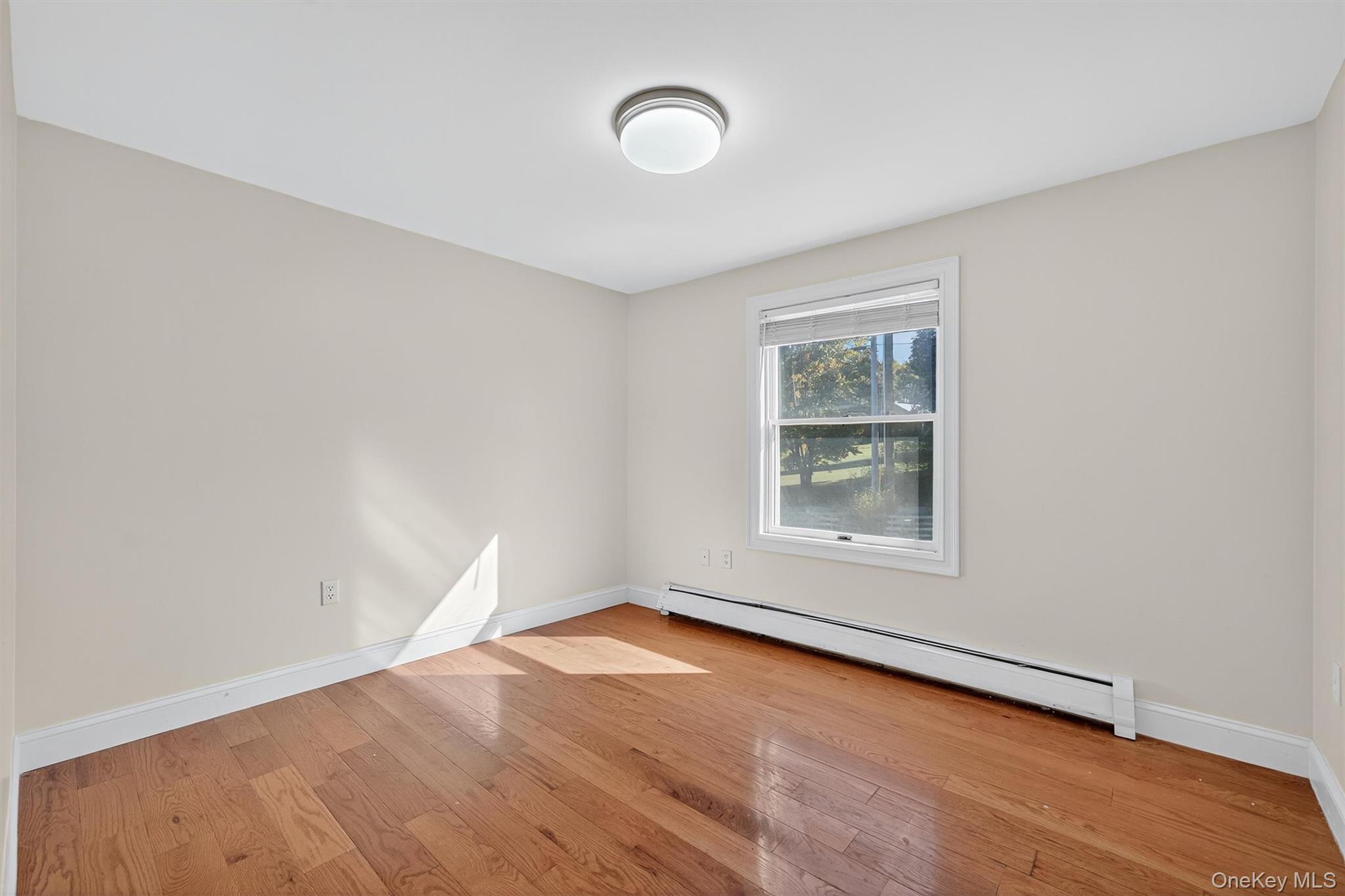 229 Gardnerville Road New Hampton, NY 10958 - Photo 27 of 50 an empty room with wooden floor and windows