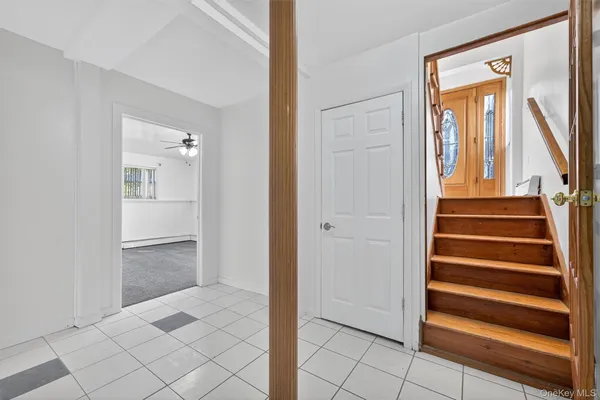 a view of an entryway with wooden floor and door