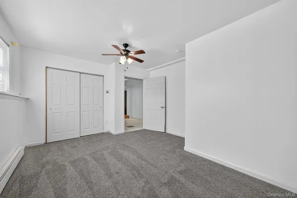 a view of an empty room with a fan