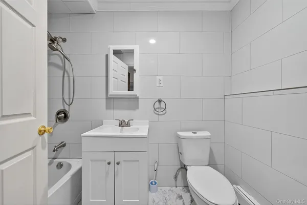 a bathroom with a sink toilet and a mirror