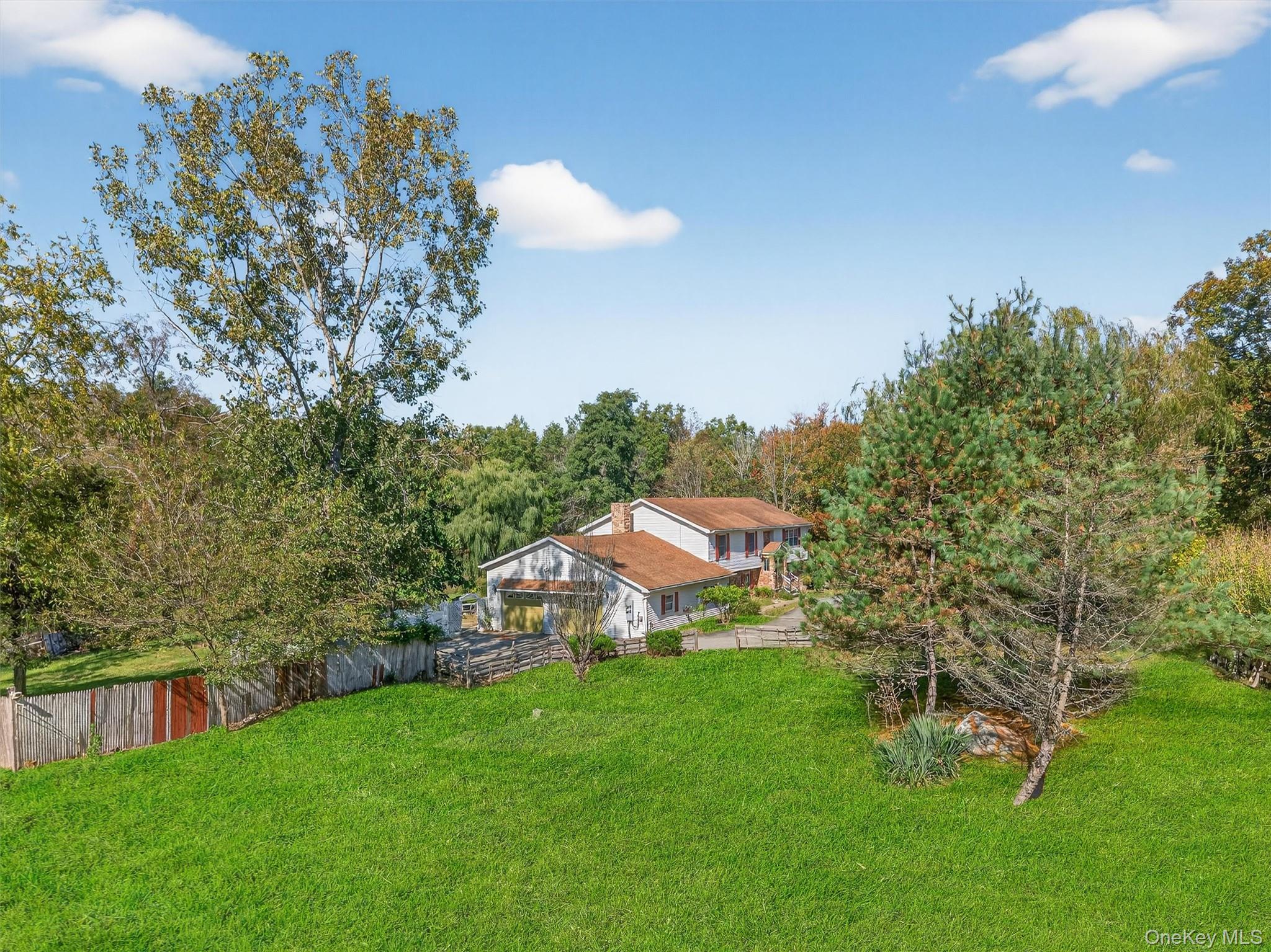 229 Gardnerville Road New Hampton, NY 10958 - Photo 4 of 50 a view of a garden with a building in the background