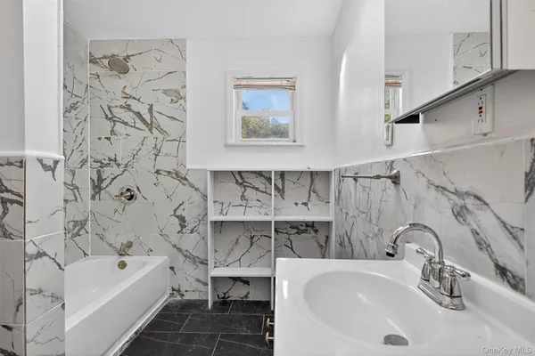 a bathroom with a bathtub sink and toilet