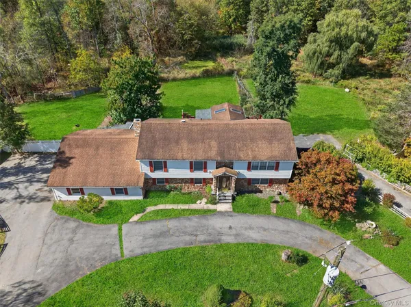 an aerial view of a house with a garden and a yard