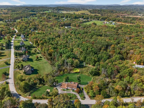 an aerial view of a houses with a yard