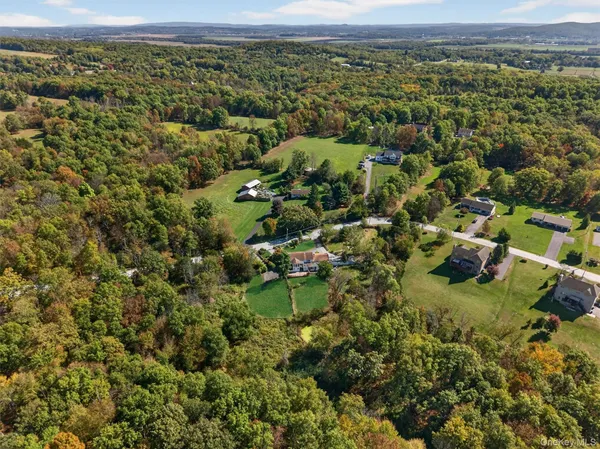 an aerial view of a houses with a yard