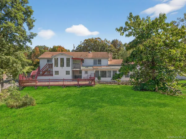 a view of a house with a backyard porch and sitting area