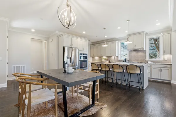 a view of kitchen with cabinets table and chairs