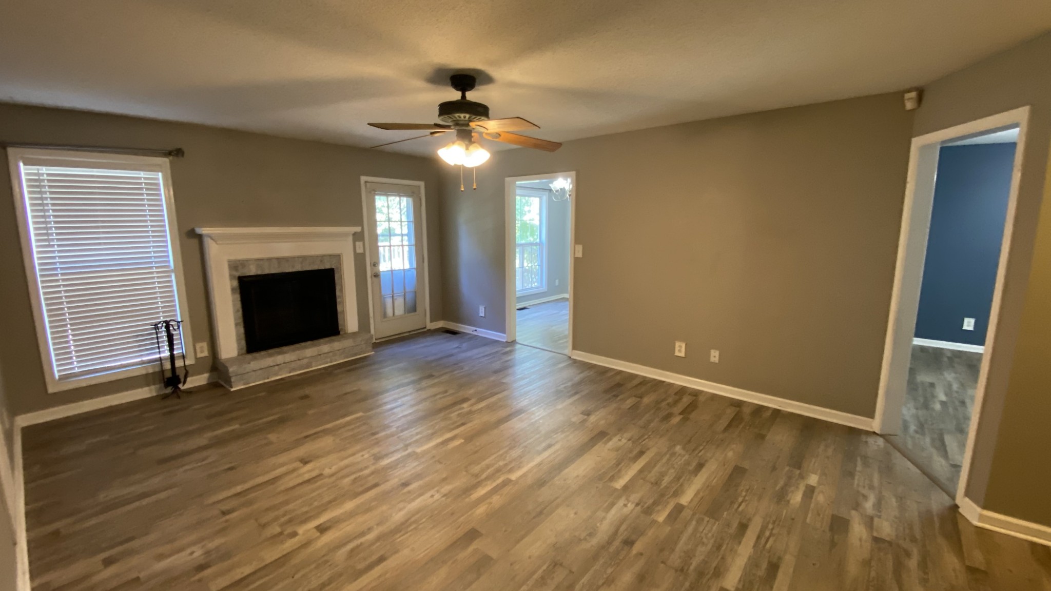 3475 Eastridge Road Woodlawn, TN 37191 - Photo 2 of 20 a view of an empty room with wooden floor fireplace and a window