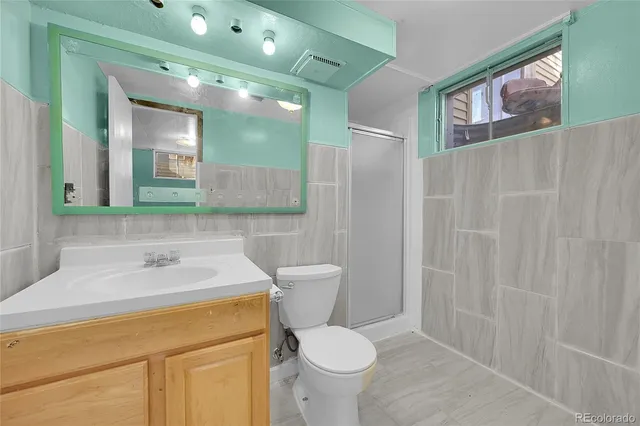 a bathroom with a sink toilet and mirror