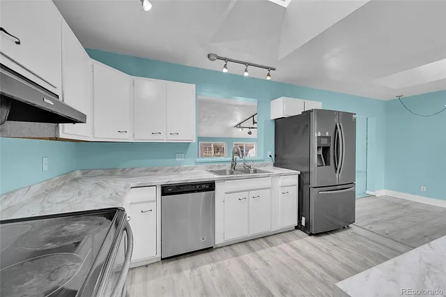 a kitchen with a sink and refrigerator