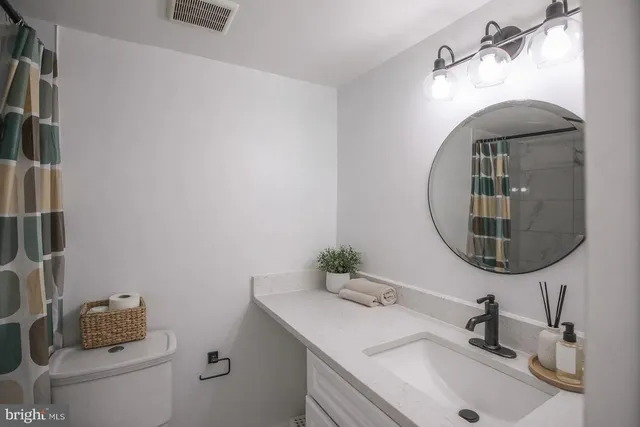 a backyard of a house with basket ball court