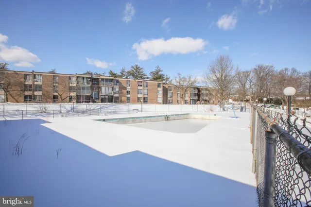 a view of a yard with wooden fence