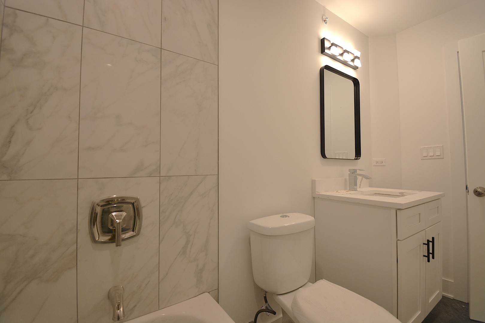 7431 Covington Place Justice, IL 60458 - Photo 19 of 23 a bathroom with a toilet a sink and mirror