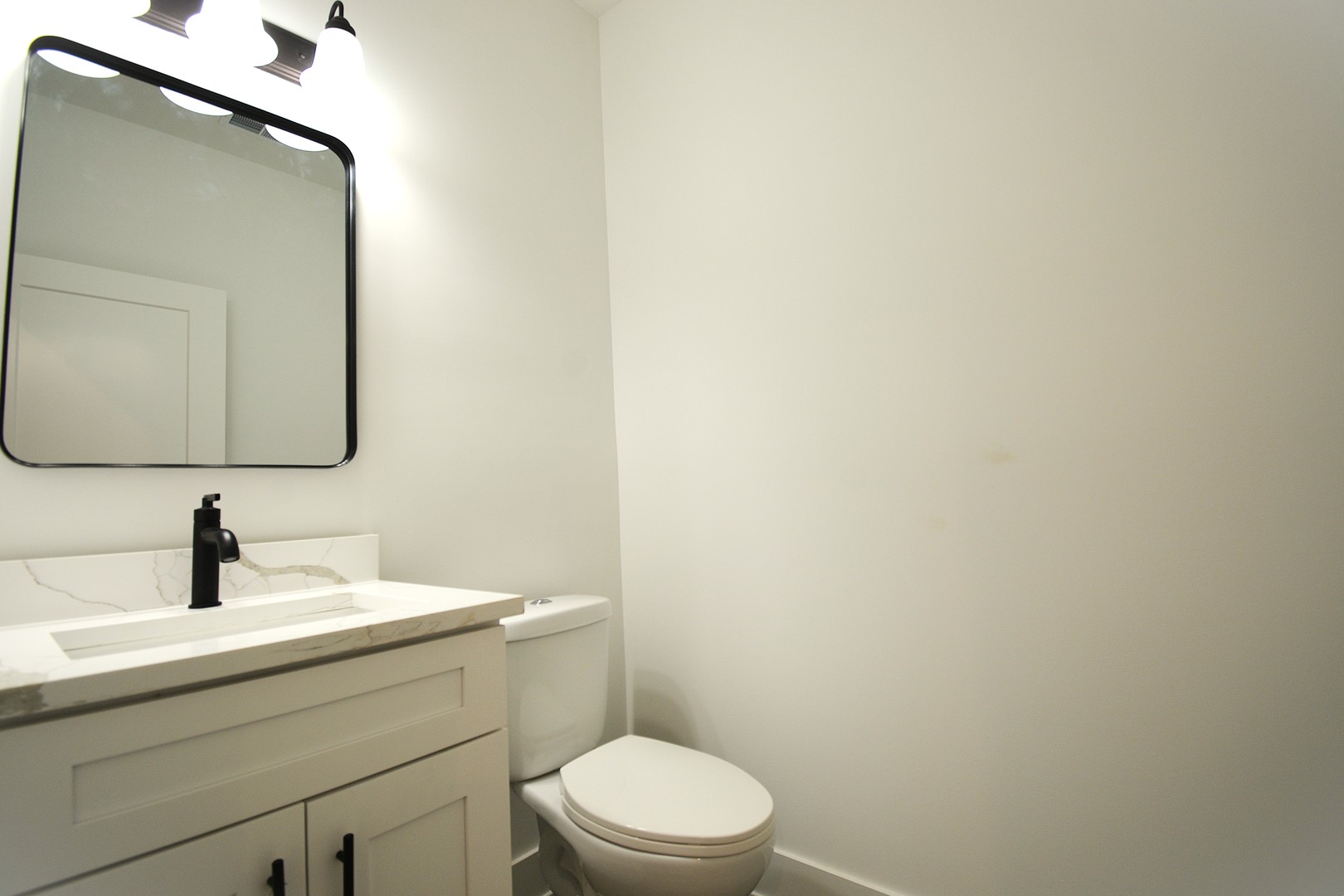 7431 Covington Place Justice, IL 60458 - Photo 5 of 23 a bathroom with a toilet a sink and mirror
