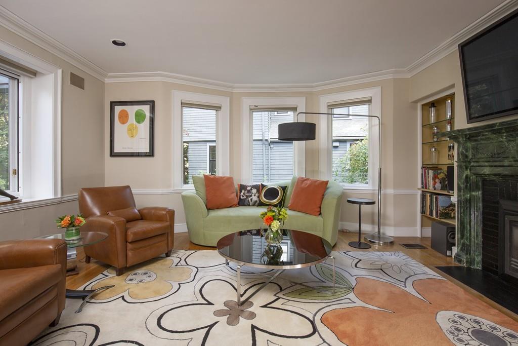 46 Griggs Road Brookline, MA 02446 - Photo 3 of 12 a living room with furniture a flat screen tv and a window