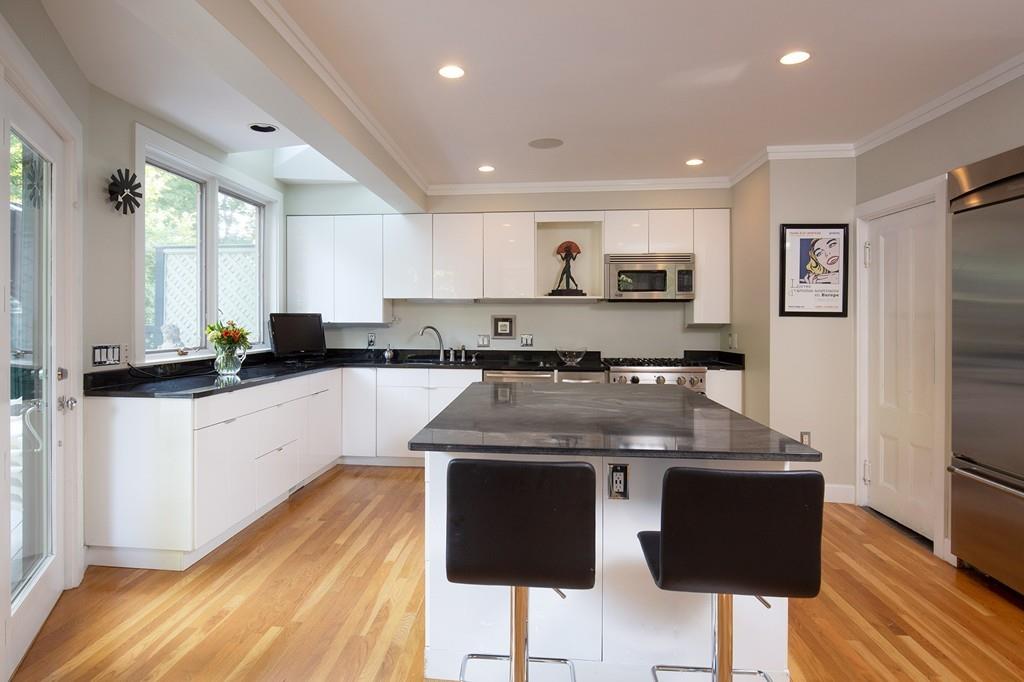 46 Griggs Road Brookline, MA 02446 - Photo 4 of 12 a kitchen with stainless steel appliances granite countertop a stove a sink and a refrigerator