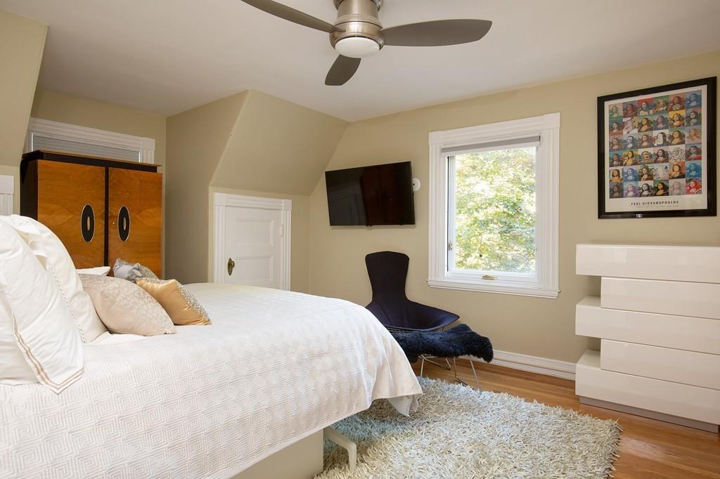 46 Griggs Road Brookline, MA 02446 - Photo 7 of 12 a bedroom with a bed window and a flat screen tv