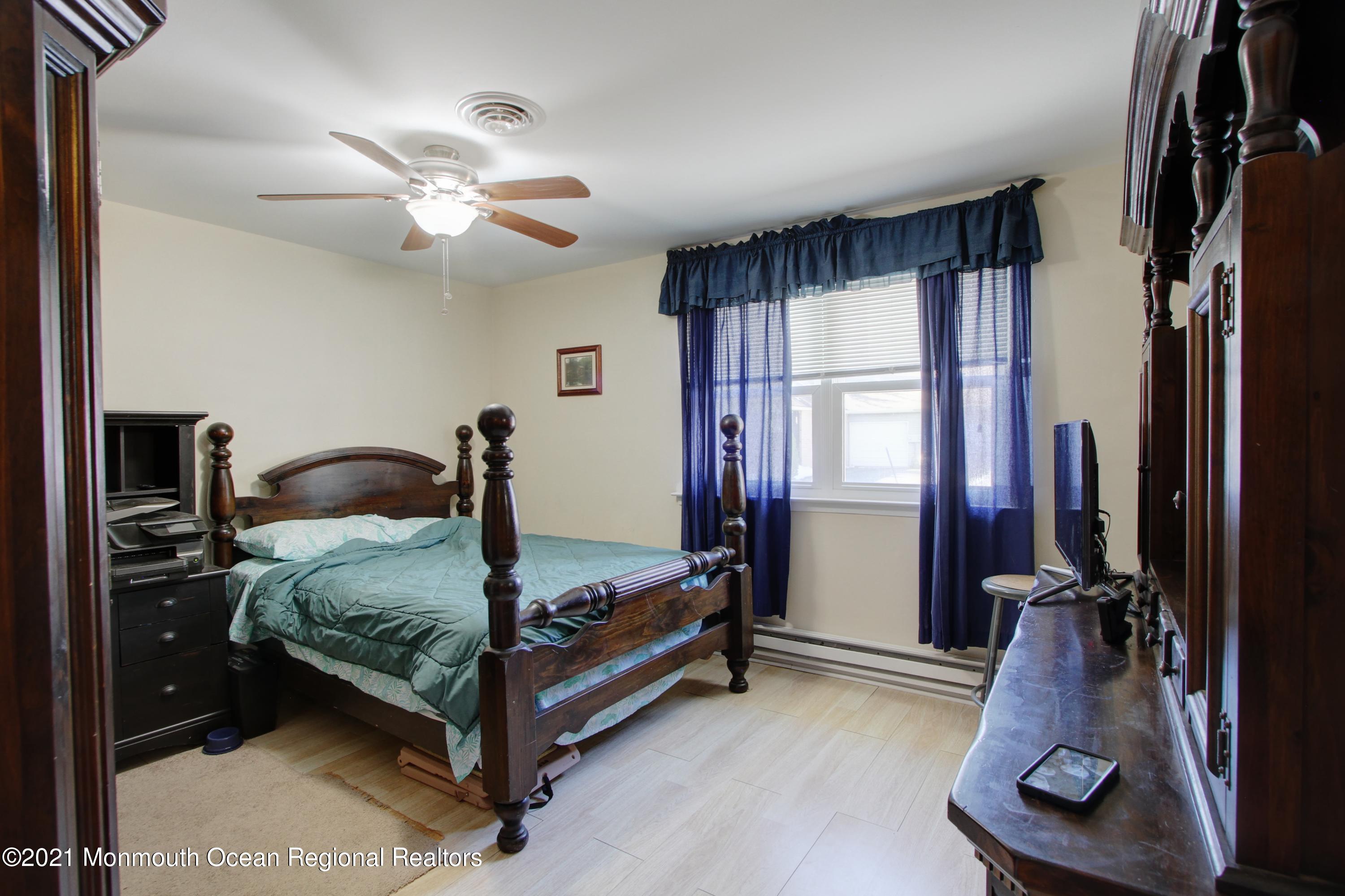 33 B Medford Road Whiting, NJ 08759 - Photo 8 of 16 a bedroom with a bed and a large mirror
